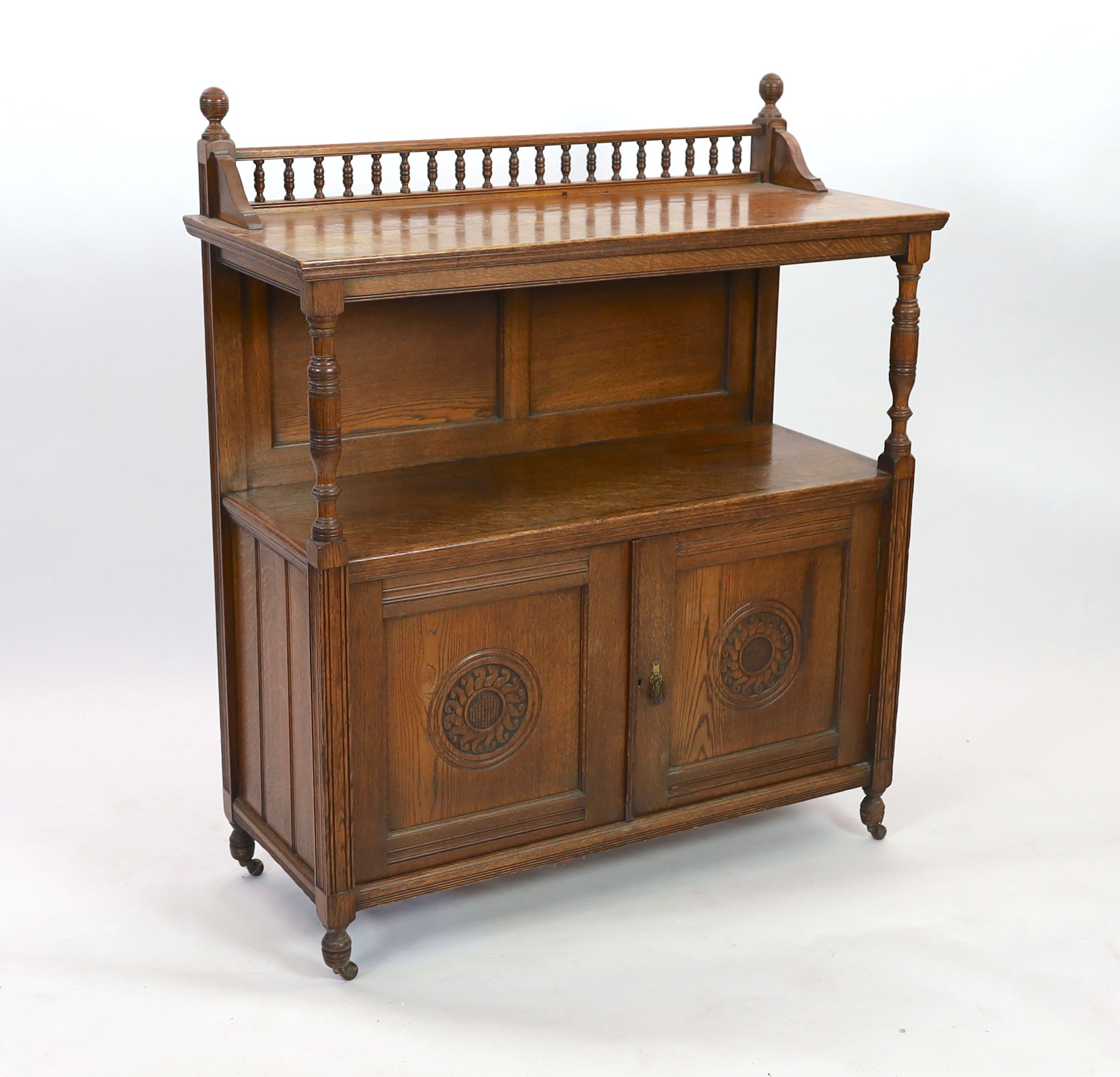 A late Victorian oak buffet, width 113cm depth 47cm height 133cm